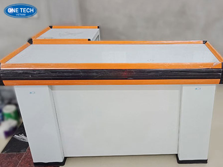 Bàn thu ngân One Tech thực tế tại cửa hàng – Thiết kế hiện đại, chắc chắn Hình ảnh thực tế bàn thu ngân One Tech với thiết kế hiện đại, tích hợp hộc tủ và ngăn kéo tiện lợi tại cửa hàng
